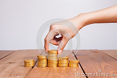 Savings, female hand stacking gold coins Stock Photo
