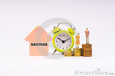 SAVINGS inscription written, alarm clock, coins and businessman miniature Stock Photo