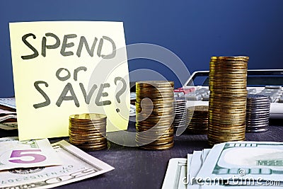 Savings. Memo stick with words save or spend. Personal finances. Stock Photo