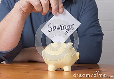 Savings into a money box Stock Photo