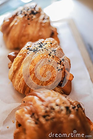 Savor the perfect union of flaky indulgence and savory delight with our mouthwatering Sausage Croissant Stock Photo