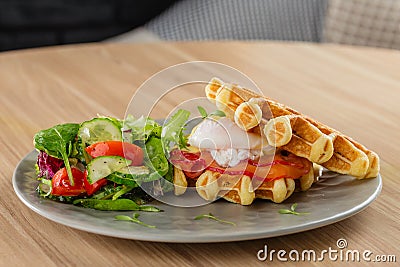 Savory Belgian waffles with egg poached, salmon and salad. eggs Stock Photo