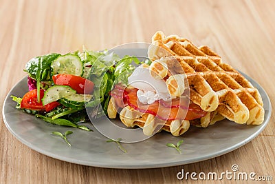 Savory Belgian waffles with egg poached, salmon and salad. eggs Stock Photo