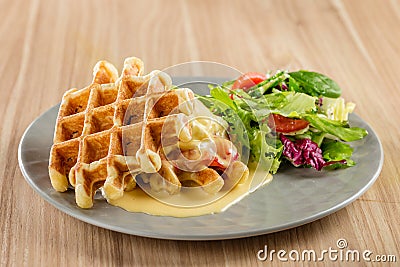 Savory Belgian waffles with mustard sauce and salad Stock Photo