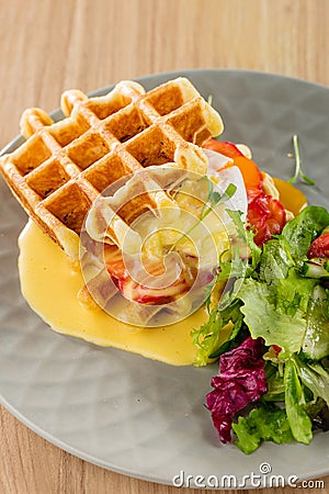 Savory Belgian waffles with mustard sauce and salad Stock Photo