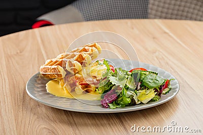 Savory Belgian waffles with mustard sauce and salad Stock Photo