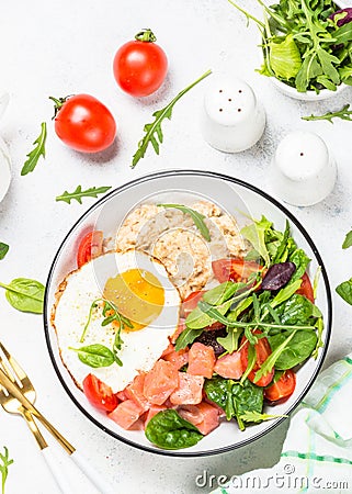 Savory breakfast with oatmeal, salmon and salad. Stock Photo