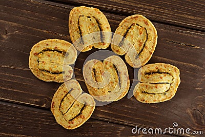 Savory cheese palmier on brown wood Stock Photo