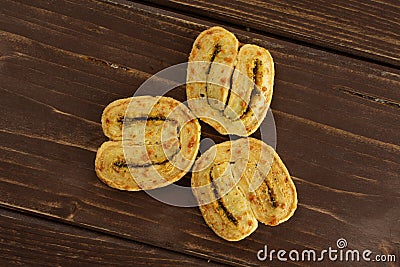 Savory cheese palmier on brown wood Stock Photo