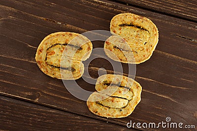 Savory cheese palmier on brown wood Stock Photo