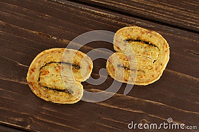 Savory cheese palmier on brown wood Stock Photo