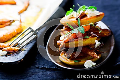 Savory chickpea pancakes with spicy roasted carrots Stock Photo