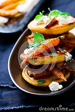 Savory chickpea pancakes with spicy roasted carrots Stock Photo