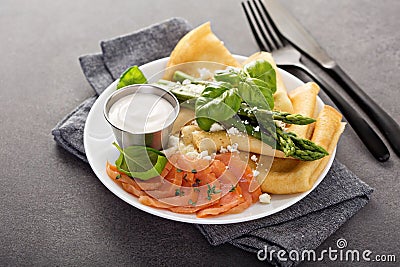 Savory crepes with salmon, sour cream and asparagus Stock Photo