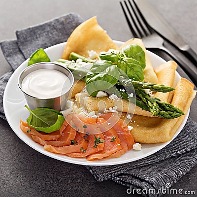 Savory crepes with salmon, sour cream and asparagus Stock Photo