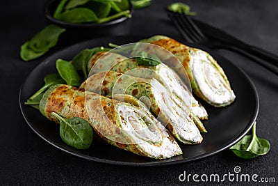 Savory crepes with spinach and feta cheese on black background Stock Photo