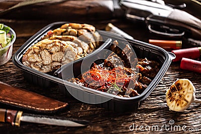 Savory and delicious deer venison goulash stew packed in portable take away plastic box. Food is served with homemade dumplings Stock Photo