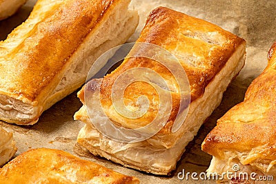 Savory filled puff pastries on baking paper. High angle Stock Photo
