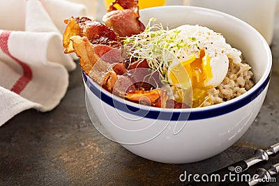 Savory oatmeal porridge with egg and bacon Stock Photo