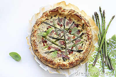 Savory pie with asparagus, ricotta and speck. Stock Photo