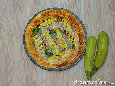 savory pie with courgettes and basil on a round plate, italian plate Stock Photo