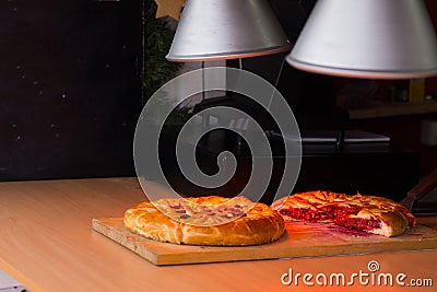 Savory pies keeping warm under heat lamps Stock Photo