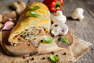 Savory strudel with mushrooms, red pepper, onion, garlic and parsley Stock Photo