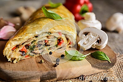 Savory strudel with mushrooms, red pepper, onion, garlic and parsley Stock Photo