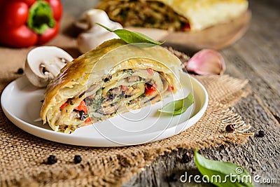 Savory strudel with mushrooms, red pepper, onion, garlic and parsley Stock Photo