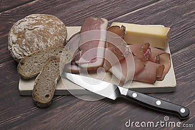 wooden background bacon cheese South Tyrolean bread Stock Photo