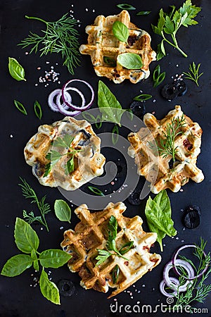 Savory waffles with cheese, ham, olives and herbs Stock Photo