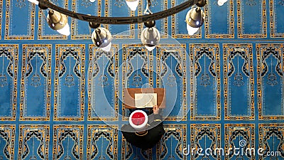 Imam reading Quran, holy book of Islam during Ramadan Editorial Stock Photo