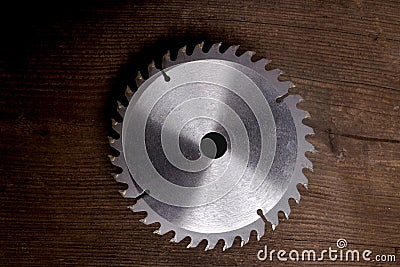 Saw blade at the old wooden table. Stock Photo