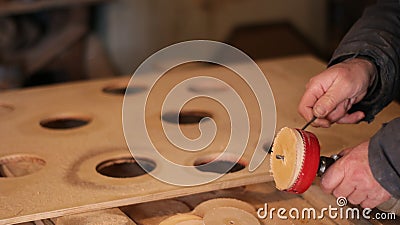 Removing a layer of wood from the round nozzle on the tool Stock Photo