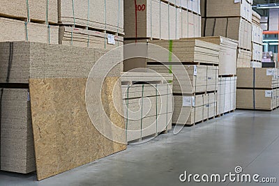 Sawn timber. Drywall, dvp, chipboard, Shelf with structural materials on the shelves in the construction warehouse. Delivery conce Stock Photo