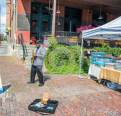 Saxman playing for the people Editorial Stock Photo