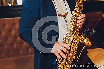 Saxophone classical music instrument Saxophonist with alto sax closeup on black. Stock Photo