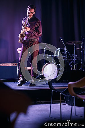 Saxophone player performing on stage Stock Photo