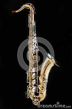 Saxophone tenor. Woodwind Classical Instrument. Jazz, blues, classics. Music. Saxophone on a black background. Black mirror surfac Stock Photo