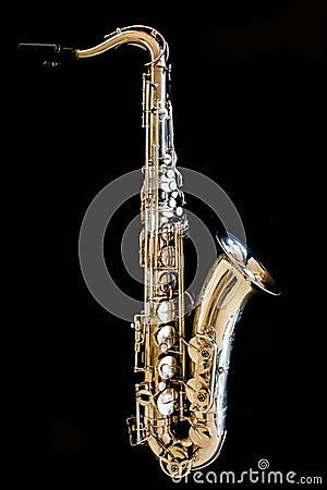 Saxophone tenor. Woodwind Classical Instrument. Jazz, blues, classics. Music. Saxophone on a black background. Black mirror surfac Stock Photo