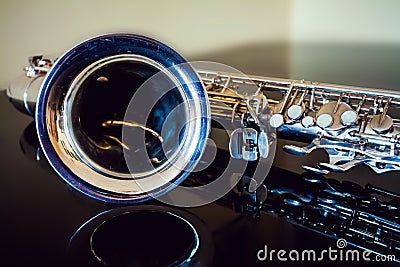 Saxophone tenor. Woodwind Classical Instrument. Jazz, blues, classics. Music. Saxophone on a black background. Black mirror surfac Stock Photo