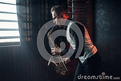 Saxophonist playing jazz melody on saxophone Stock Photo