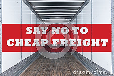 Say no to cheap freight written on empty commercial semi trailer interior. Concept of american truckers protest due to load rates Stock Photo