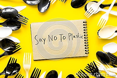 Say no to plastic copy. Eco concept and injunction on the use of plastic flatware on yellow background top view Stock Photo