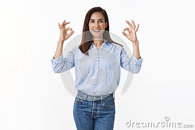 Say okay. Motivated good-looking adult businesswoman encouraged deal any proble, show ok approval, acceptance gesture Stock Photo