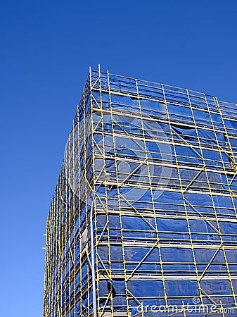 Scaffolding and Blue Safety Cladding on Construction Stock Photo