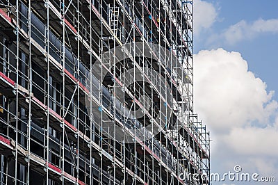Scaffolding at construction site of a glass office building Stock Photo