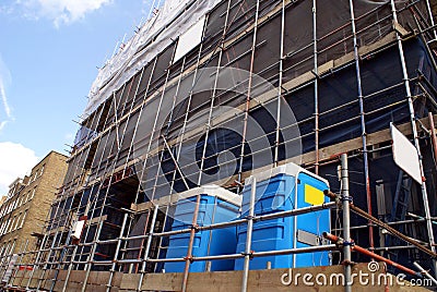 Scaffolding. construction site. portable toilets Stock Photo