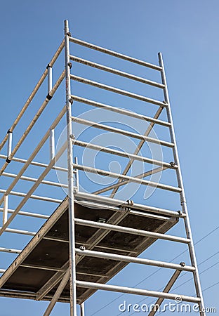 Scaffolding, metal mobile scaffold aginst blue sky background Stock Photo