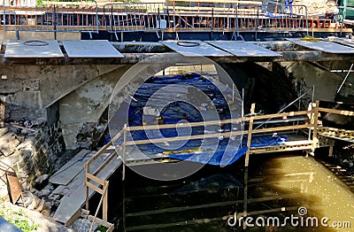 scaffolding surrounds the bridge, serving as a temporary footbridge. Stock Photo